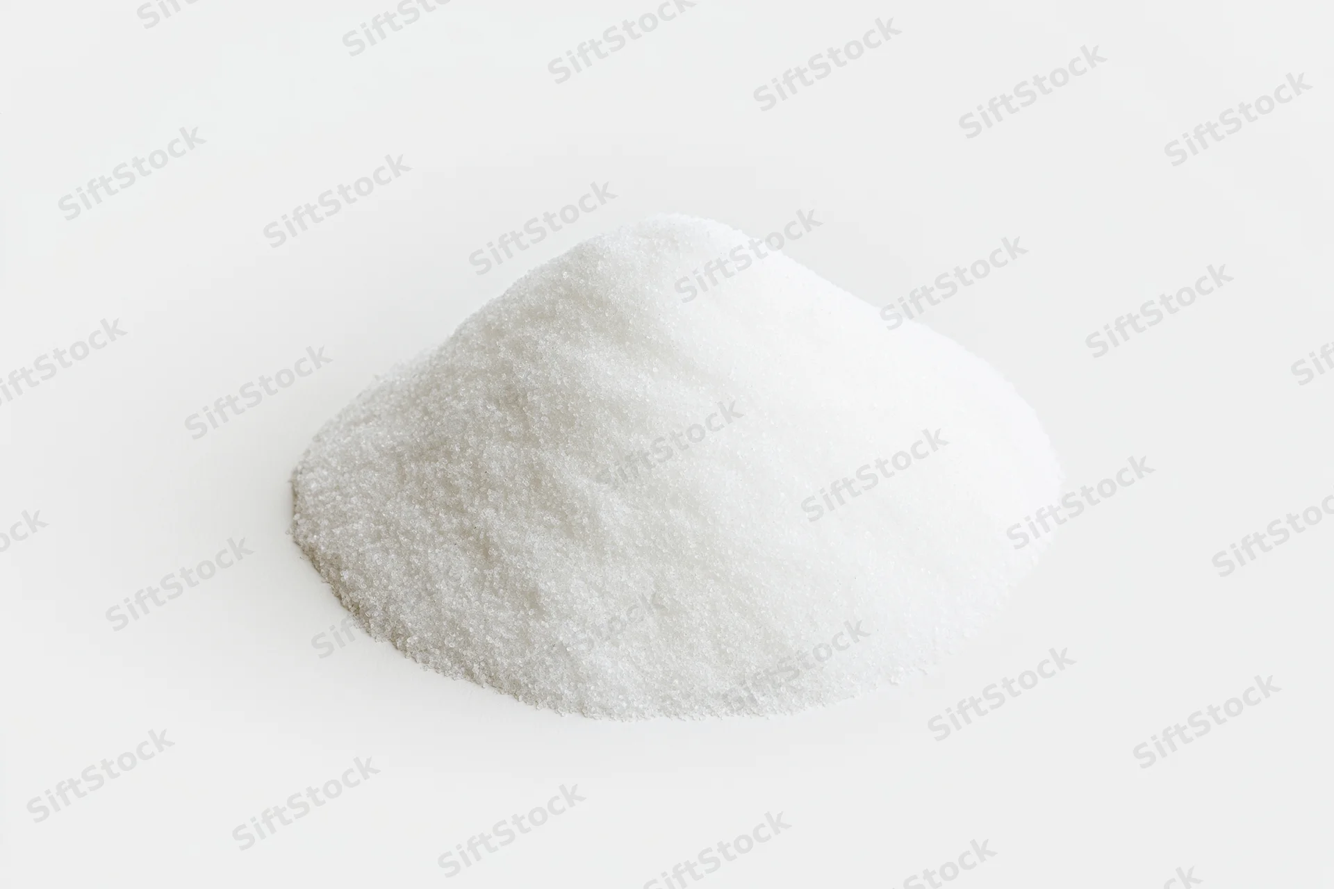 Mound of fine white salt granules on a plain white surface