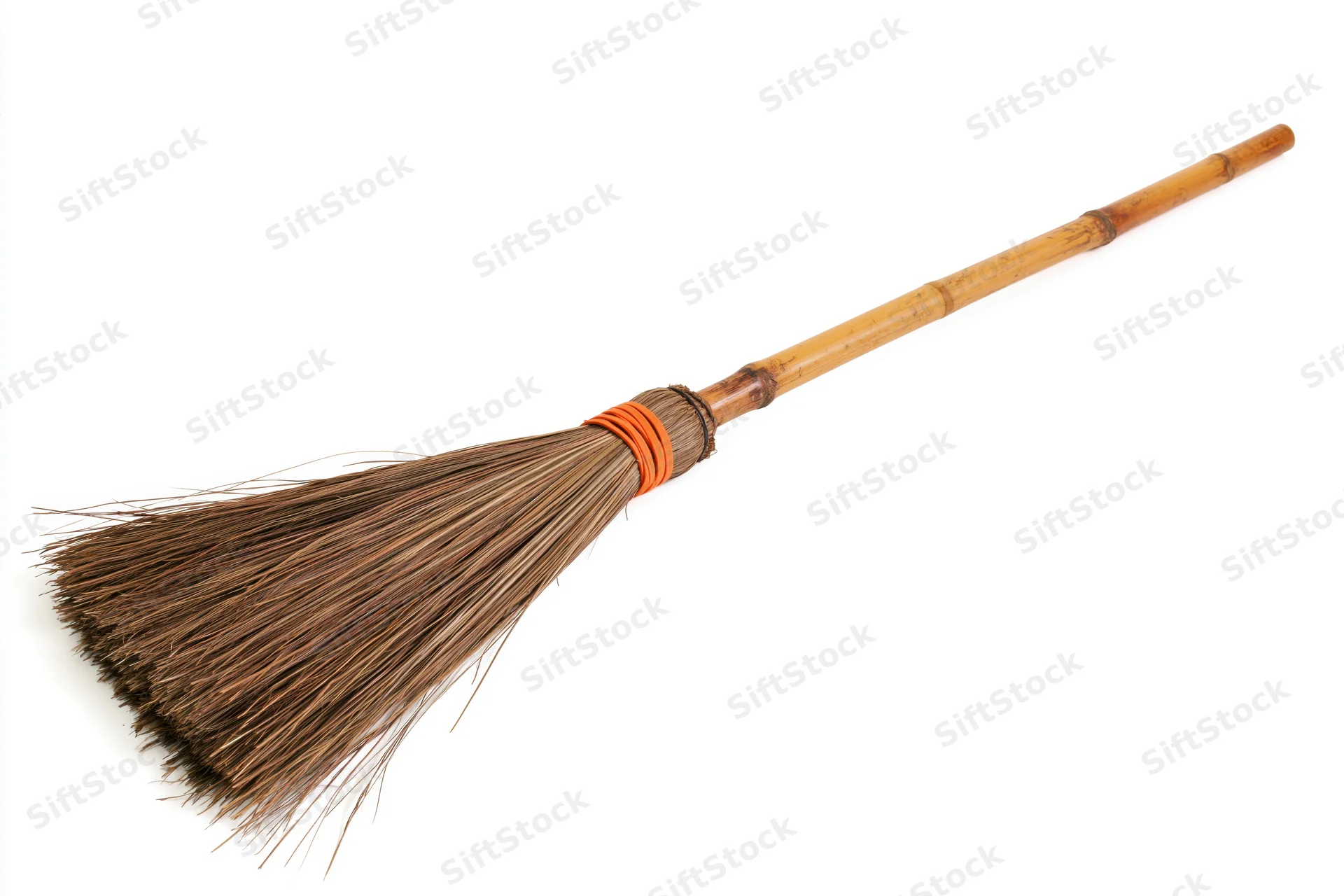 Traditional bamboo-handled broom with dried brown straw bristles on white background