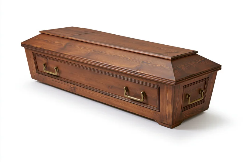 Traditional wooden coffin with brass side handles angled view isolated on white background