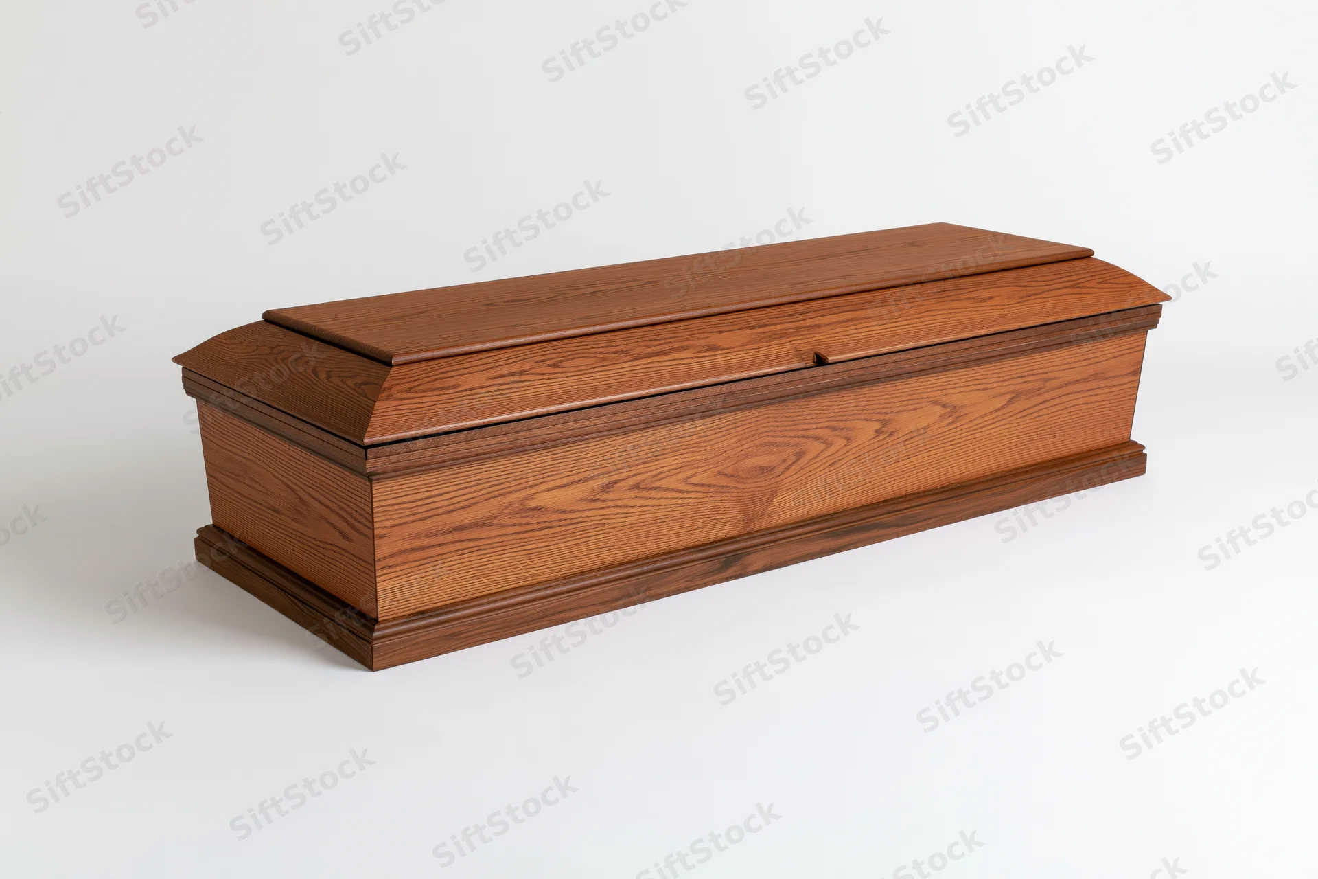 Wooden coffin with closed lid angled three-quarter view on white background
