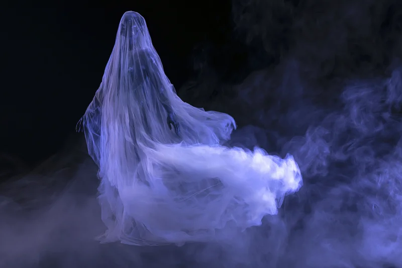 Ghostly figure floating in billowing sheer fabric amidst swirling smoke in dark space