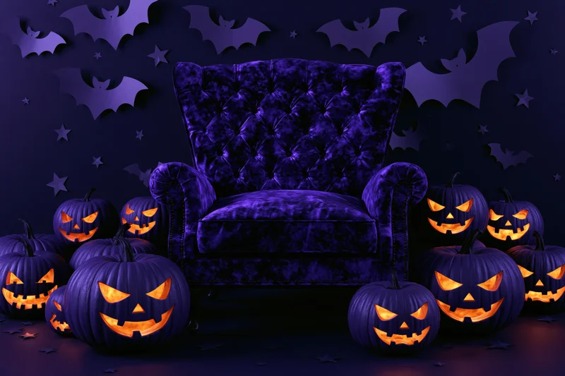 Tufted purple velvet armchair surrounded by glowing carved pumpkins and bats in a dark halloween-themed interior
