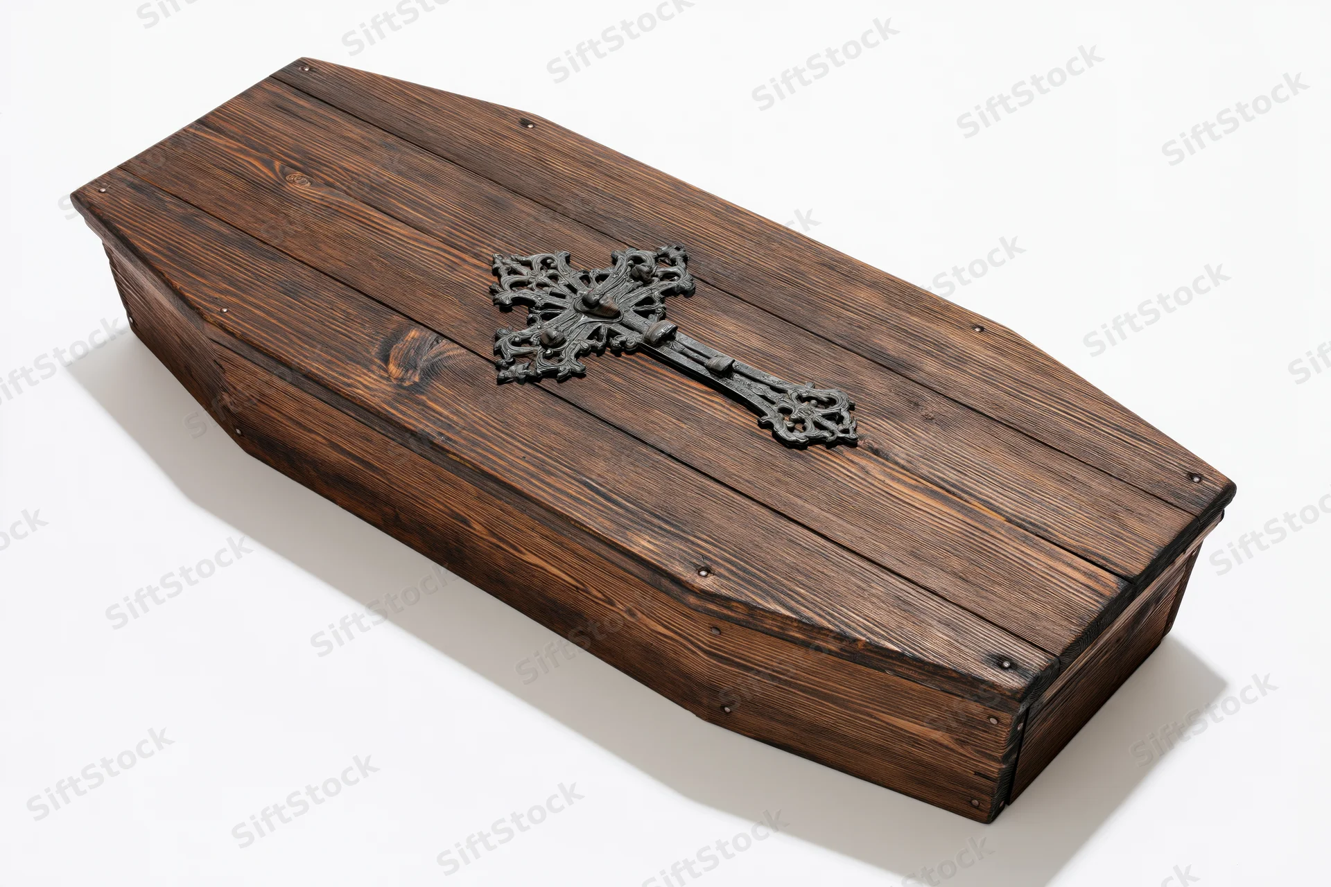 Wooden coffin lid with decorative metal cross on white background