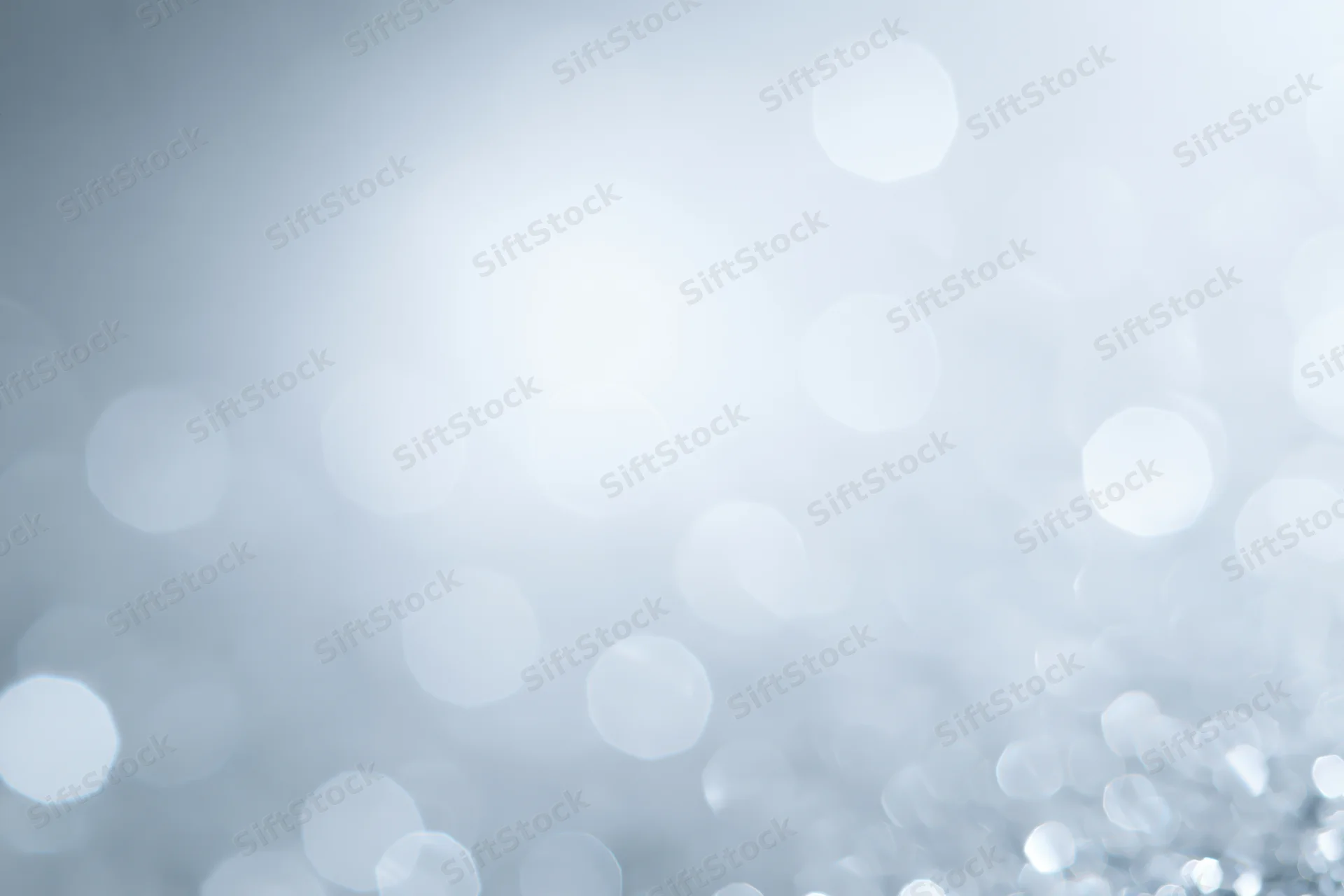 Abstract defocused bokeh background with soft white and silver light circles