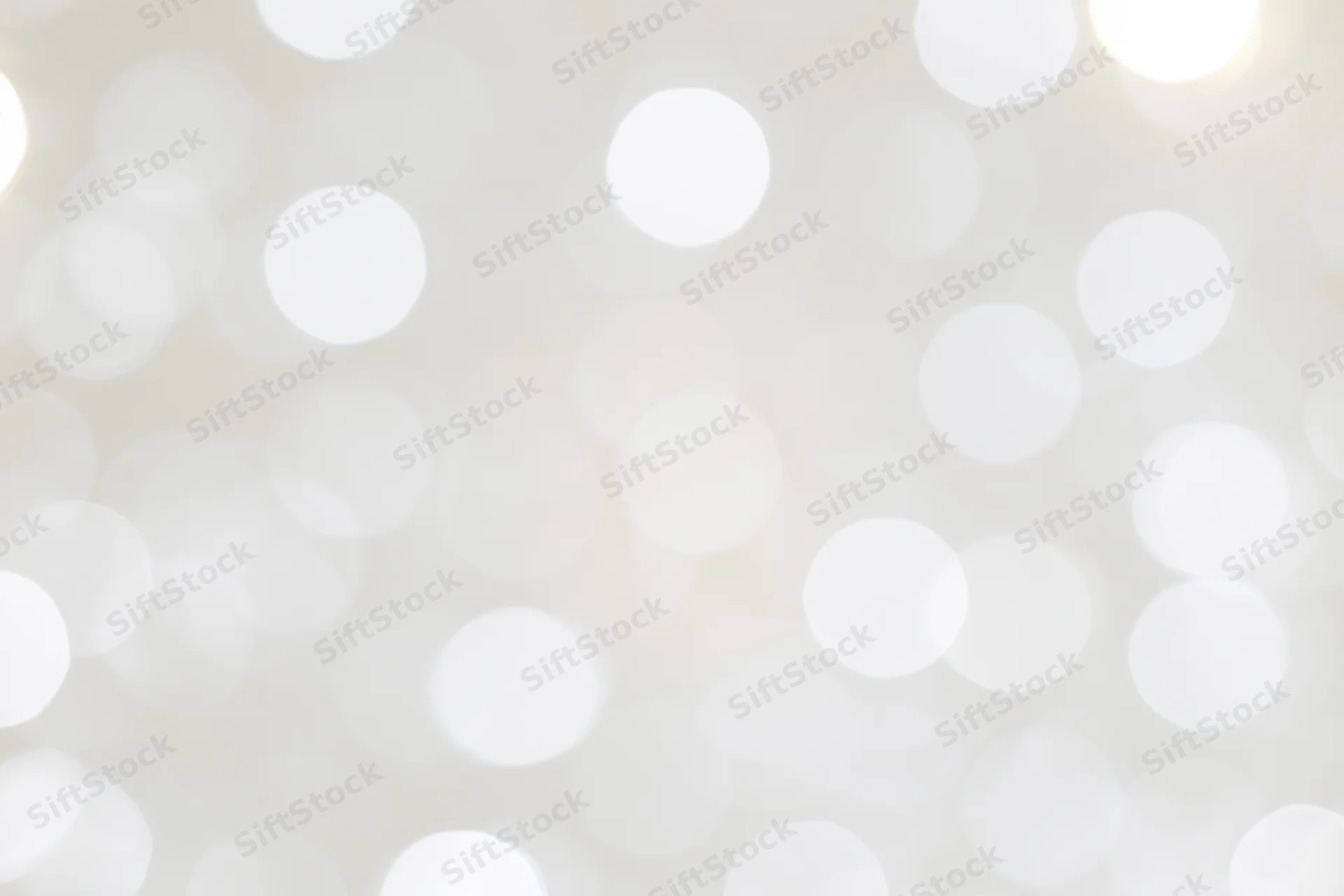 Abstract bokeh background with soft white circular lights filling the frame