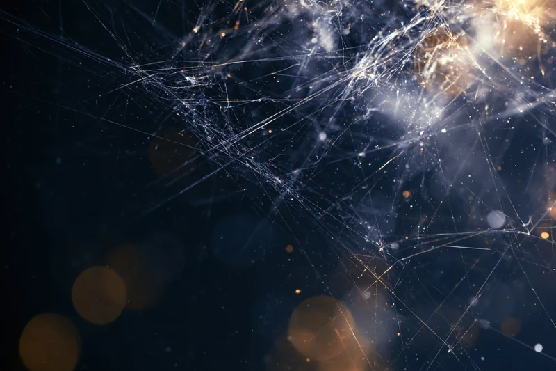 Abstract network of glowing threads and particles against dark background