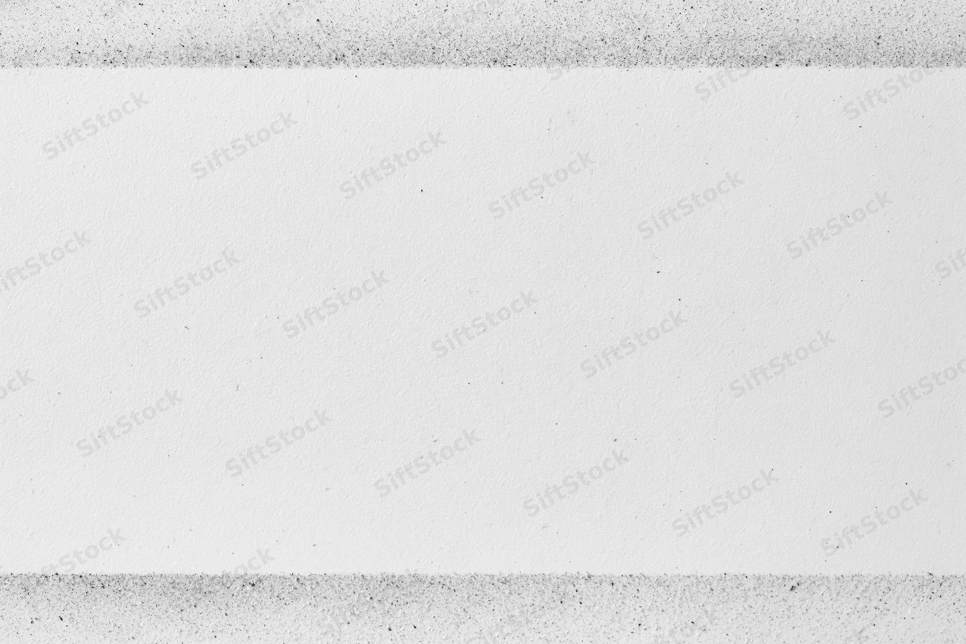 White paper texture with faint grey speckled dust and grain, flat surface view