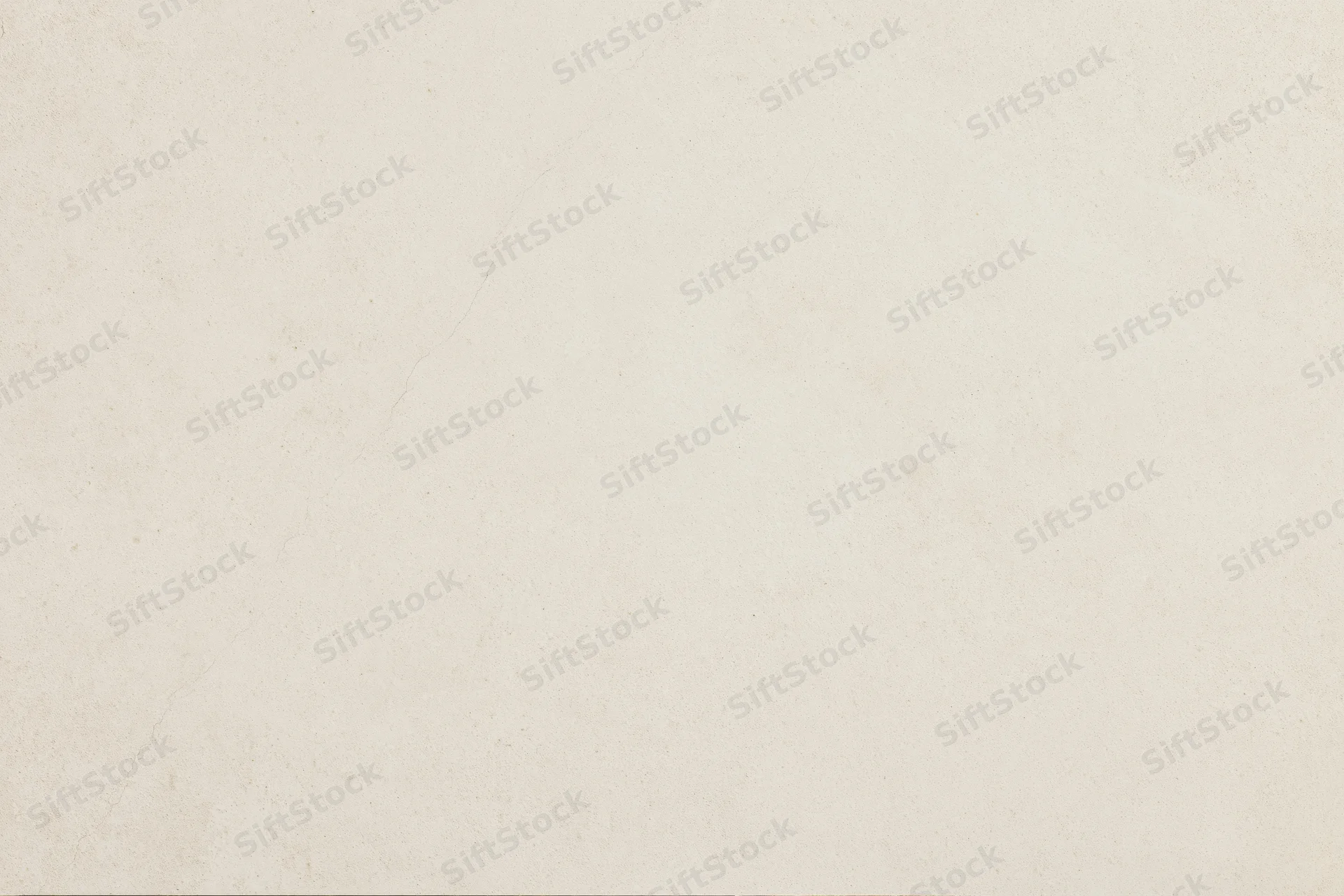 Close-up of smooth beige concrete or plaster wall surface with subtle texture and neutral tone