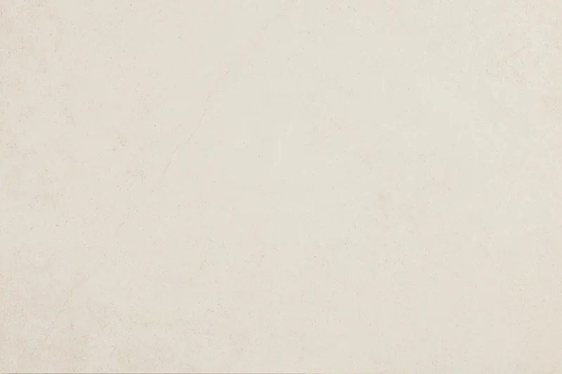 Close-up of smooth beige concrete or plaster wall surface with subtle texture and neutral tone