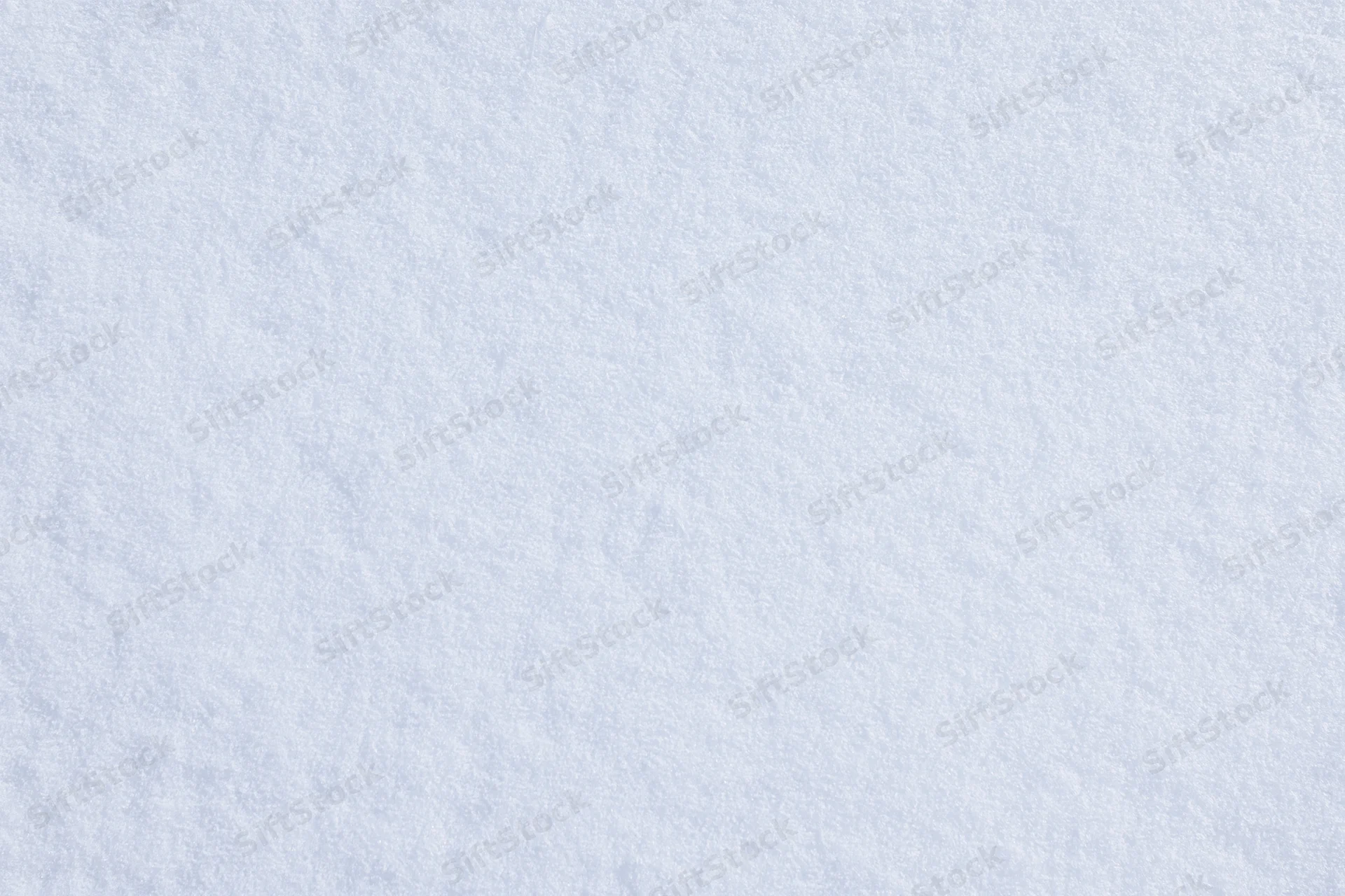 Close-up flat lay of smooth fresh snow surface filling the frame