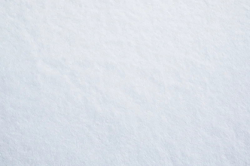 Close-up flat lay of smooth fresh snow surface filling the frame