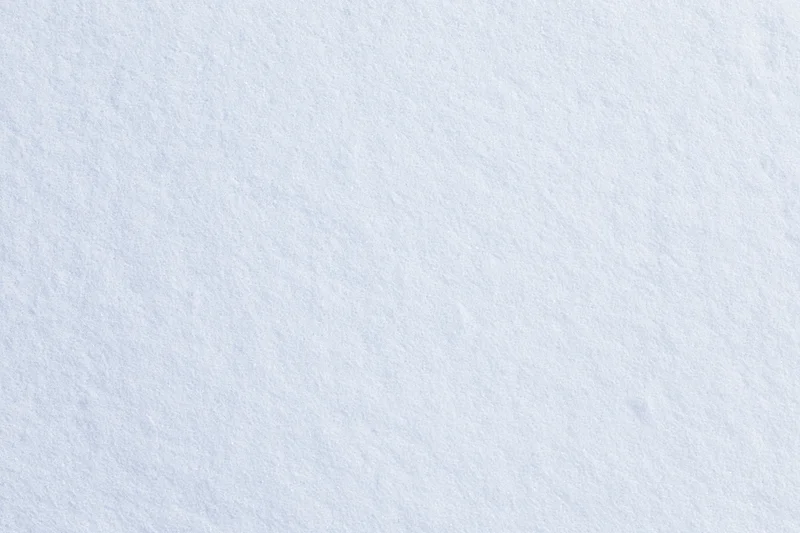 Close-up flat lay of a smooth fresh snow surface filling the frame