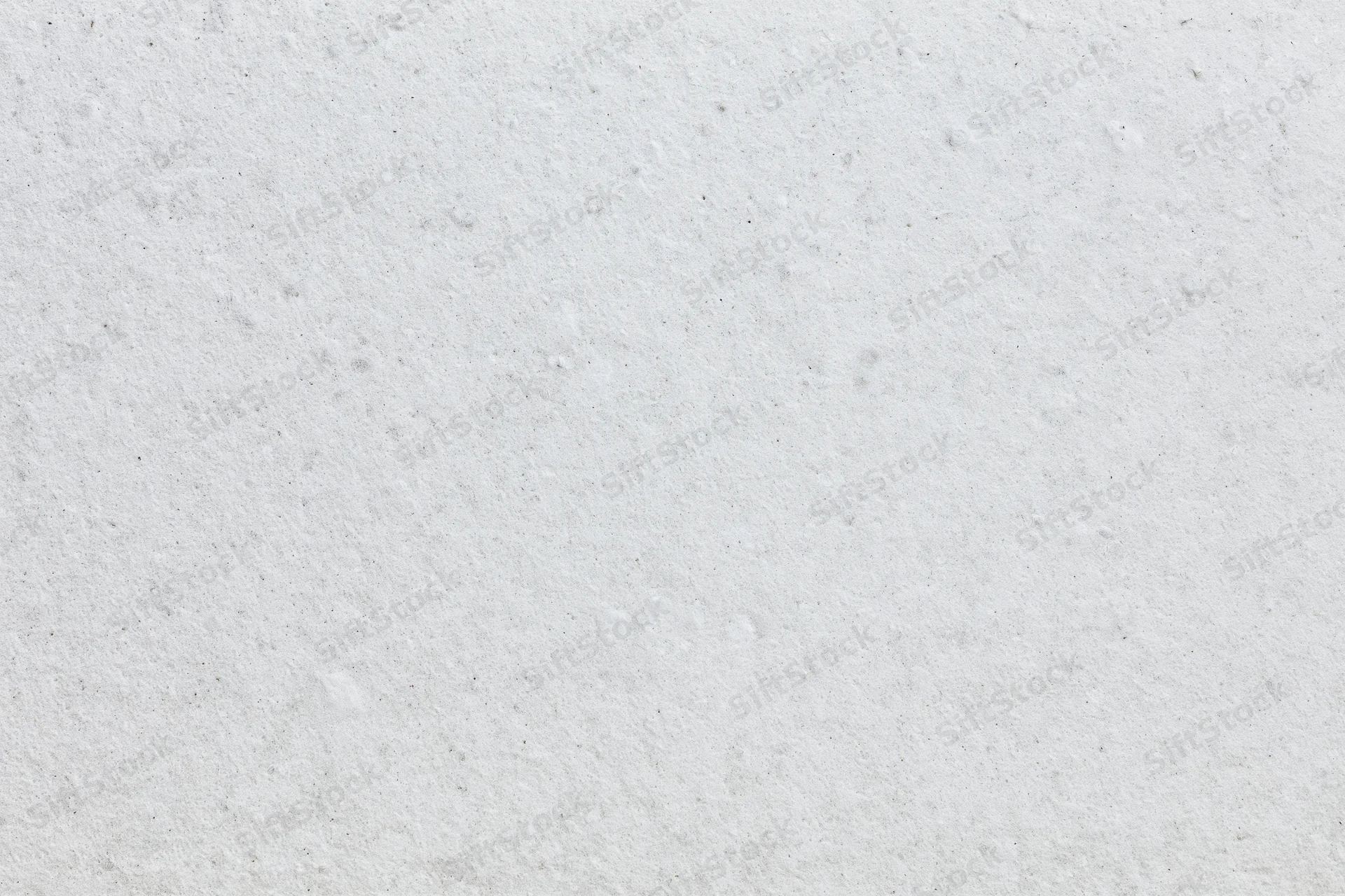 Close-up of white concrete surface with rough texture filling the frame