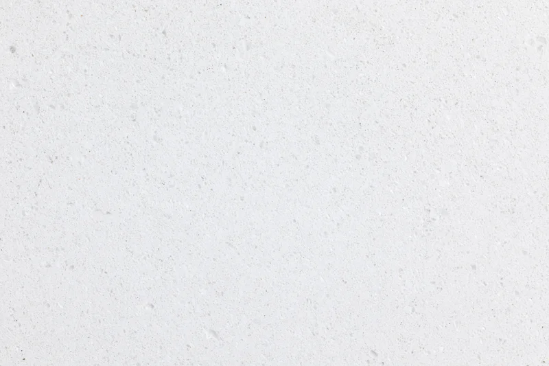 Close-up of a white concrete surface with speckled texture filling the frame