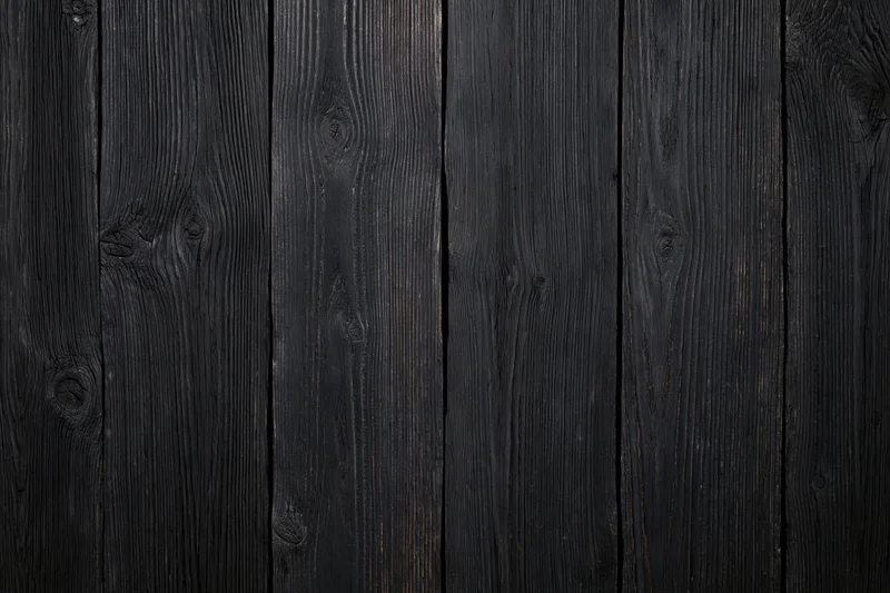 Dark weathered wood planks arranged vertically showing natural grain and texture