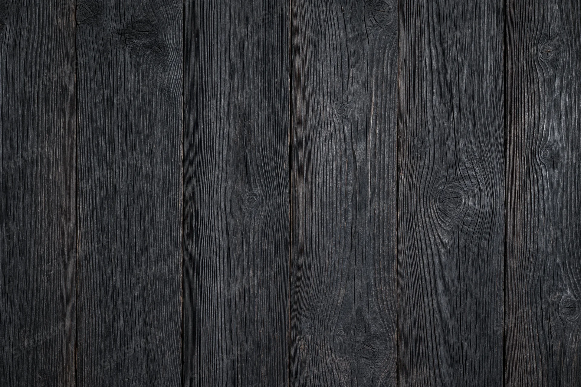 Dark weathered wood planks arranged vertically as a textured surface