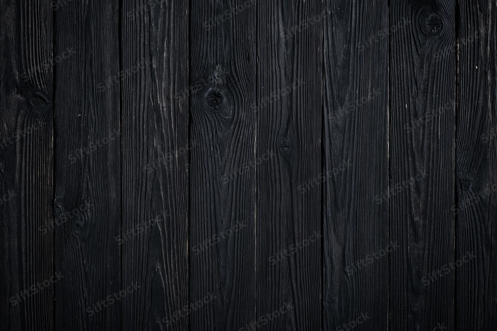 Dark weathered wood planks arranged vertically as a textured surface