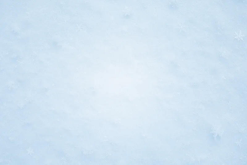 Close-up of fresh snow surface with scattered snowflakes in winter