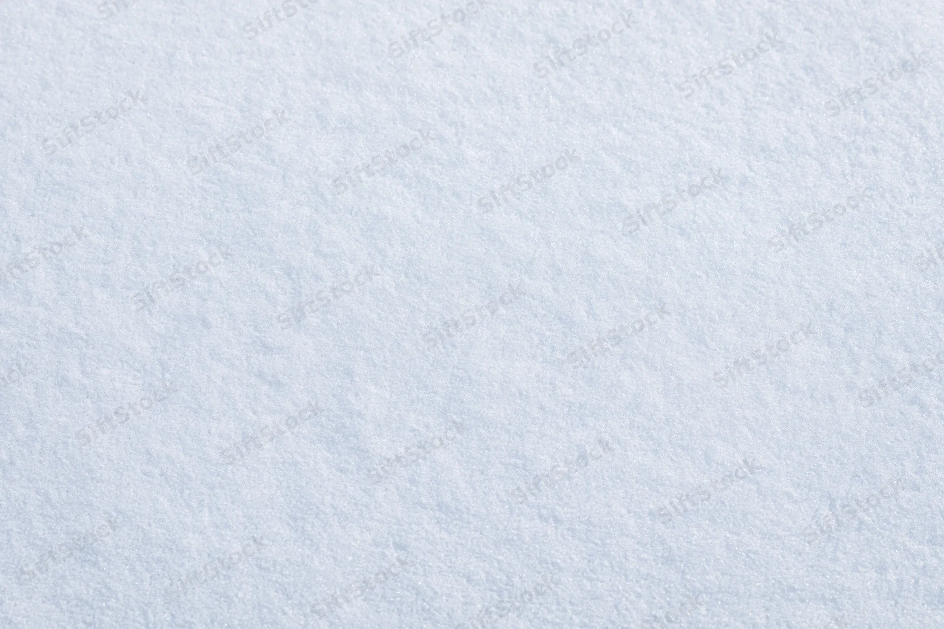 Close-up flat lay of fresh undisturbed snow surface filling the frame