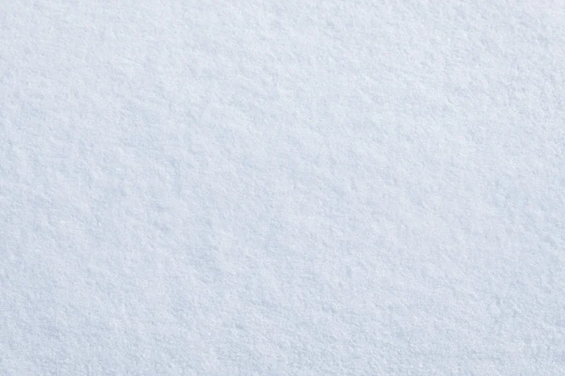 Close-up flat lay of fresh undisturbed snow surface filling the frame