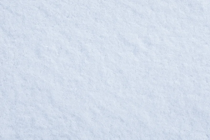 Close-up flat lay of undisturbed fresh snow surface filling the frame