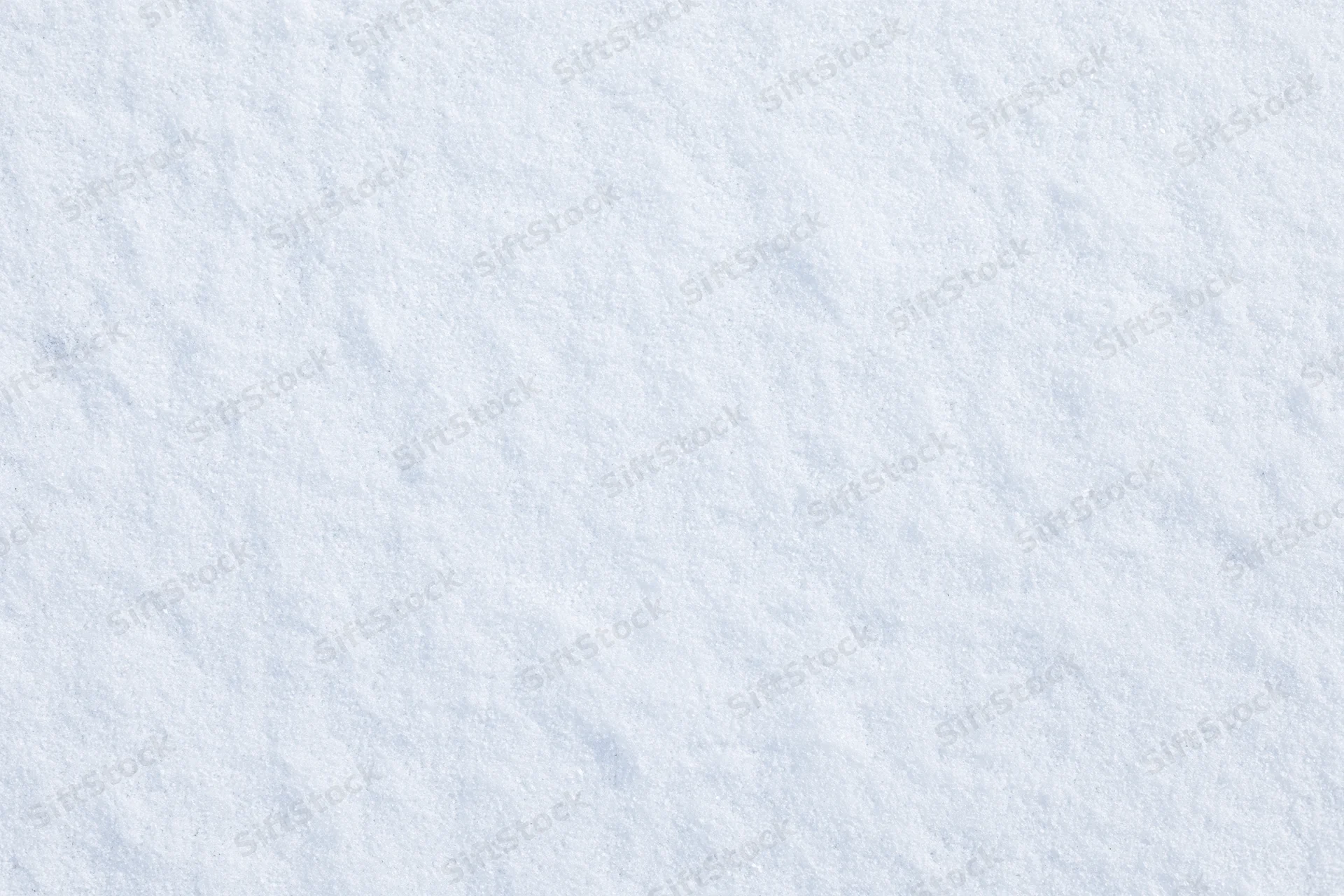 Close-up flat lay of undisturbed fresh snow surface filling the frame