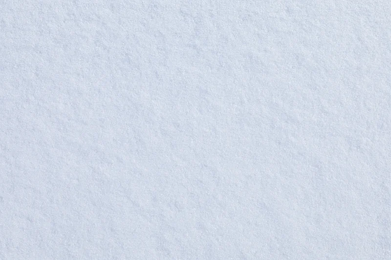 Close-up flat lay of undisturbed fresh snow surface filling the frame