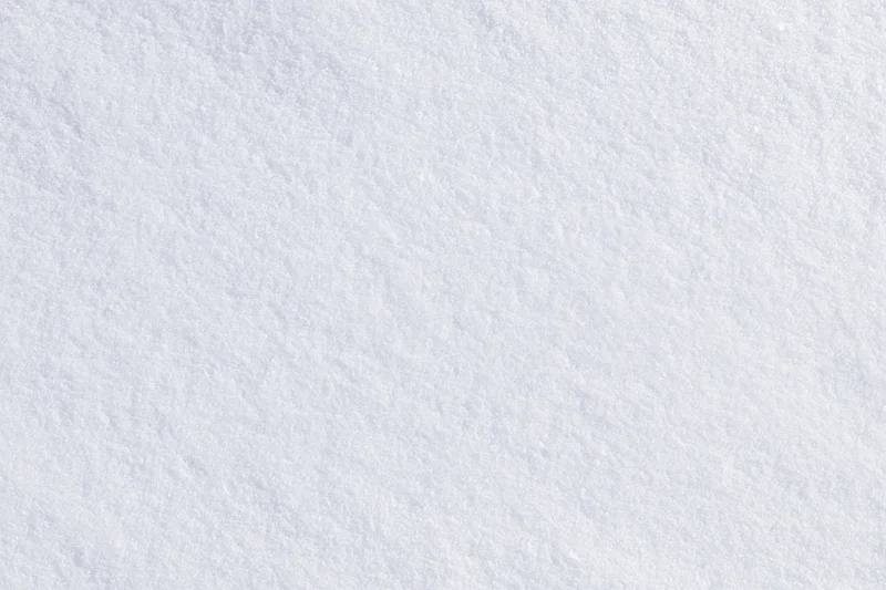 Close-up flat lay of undisturbed fresh snow surface filling the frame