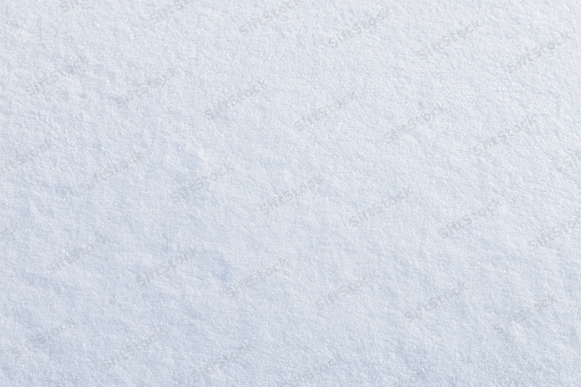 Close-up flat lay of undisturbed fresh snow surface filling the frame