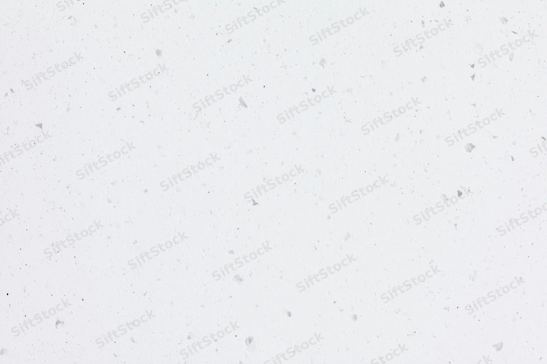 Close-up flat lay of white speckled paper or quartz surface texture