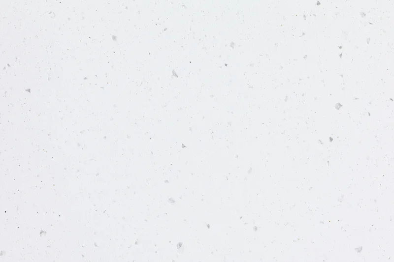 Close-up flat lay of white speckled paper or quartz surface texture