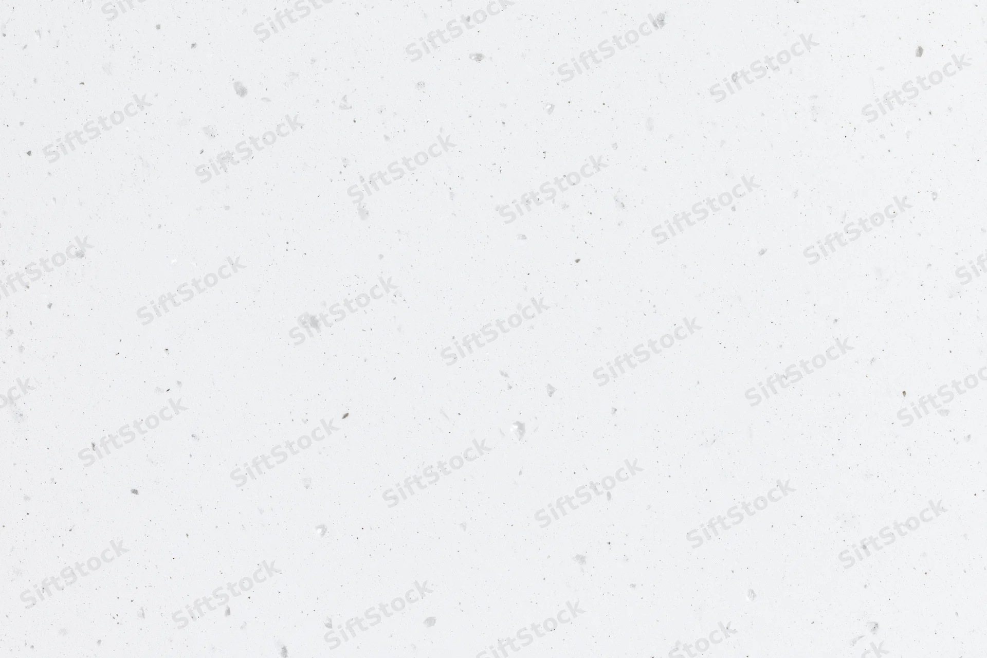 Close-up flat lay of white speckled paper or quartz surface texture