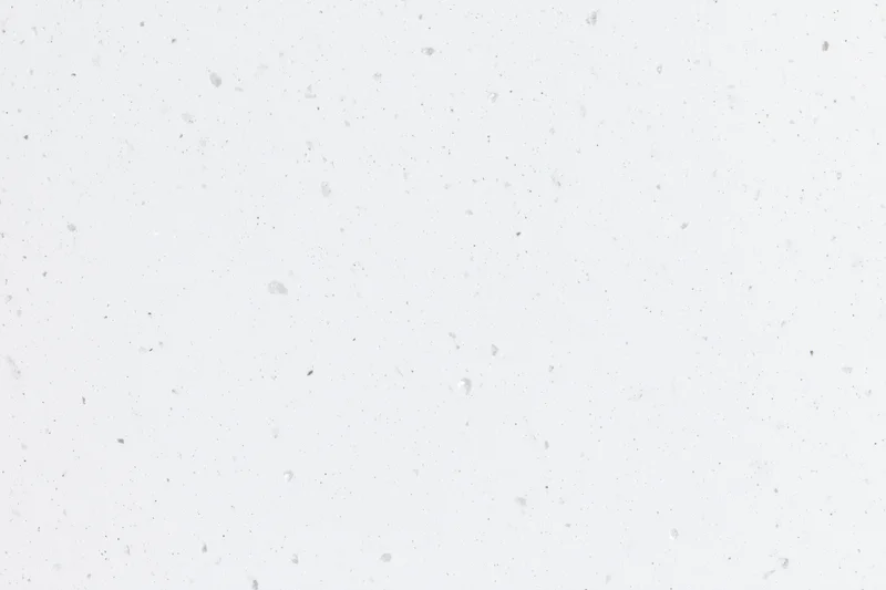 Close-up flat lay of white speckled paper or quartz surface texture