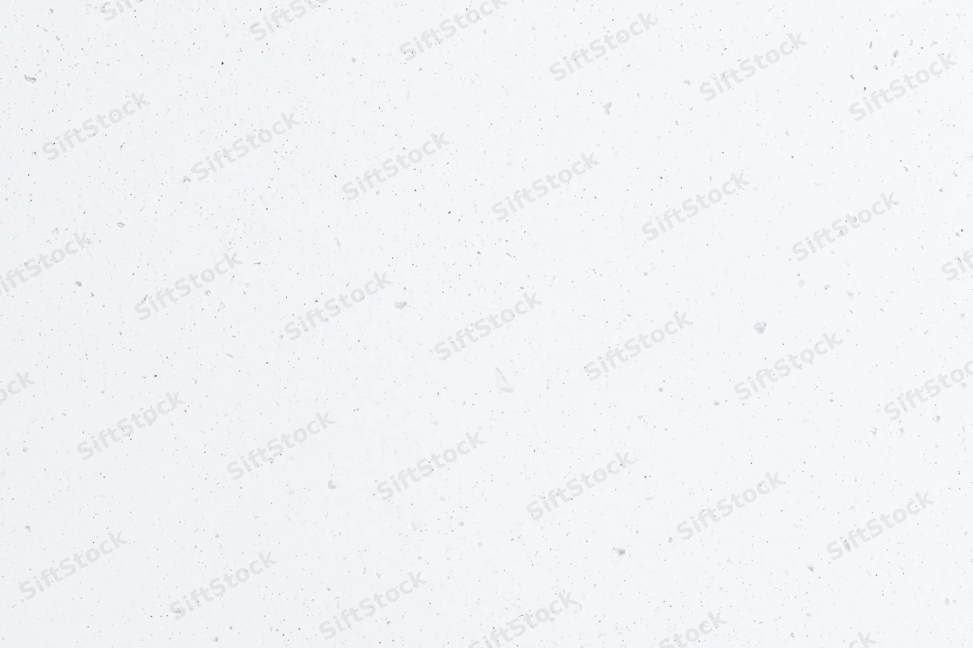 Close-up flat lay of white speckled paper or quartz surface texture