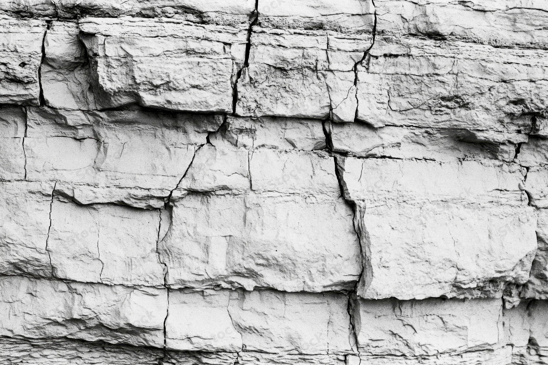 Close-up of layered sedimentary rock face showing natural strata and fractures