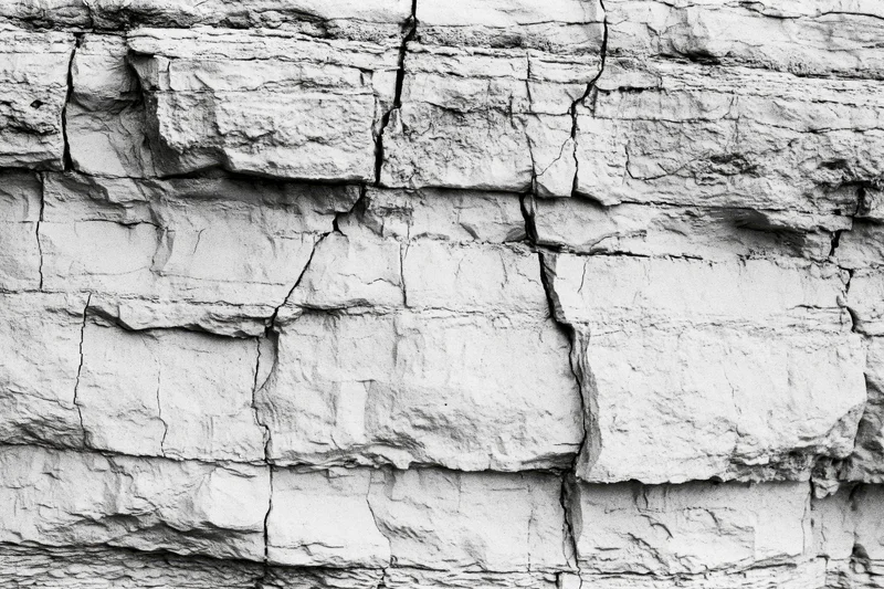 Close-up of layered sedimentary rock face showing natural strata and fractures