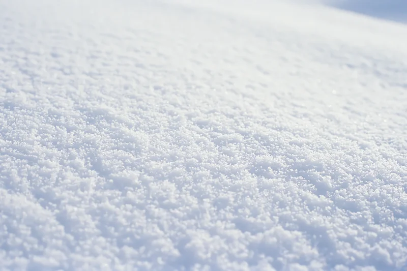 Close-up of fresh undisturbed snow surface on the ground