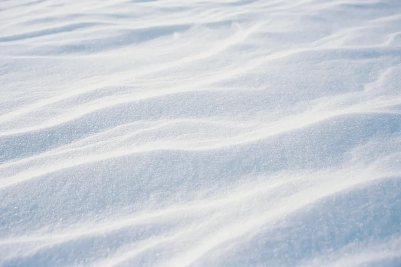 Closeup of undisturbed snow surface with wind-formed ridges and sparkling texture