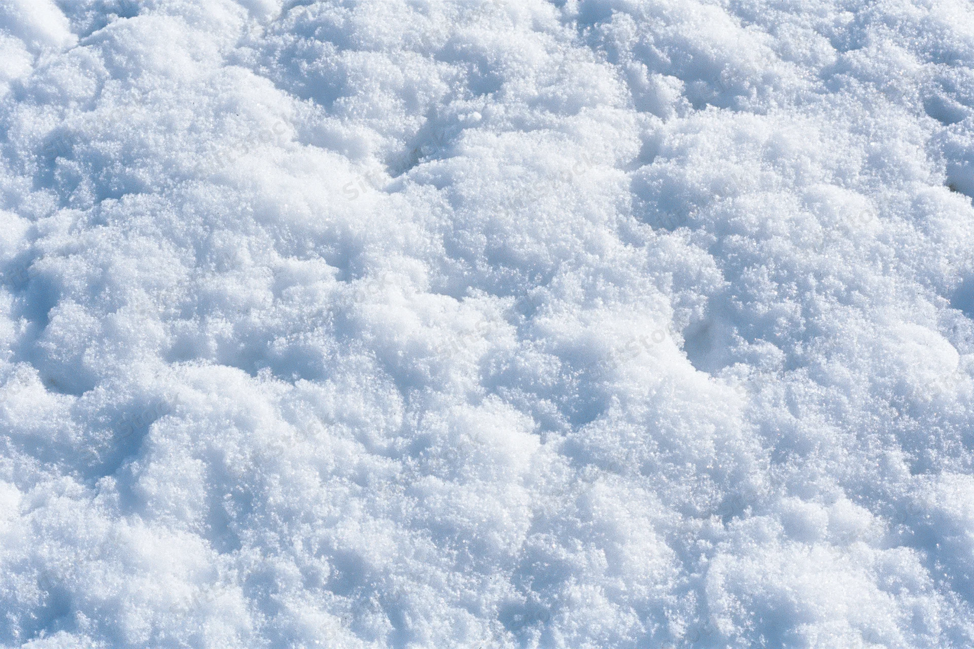 Close-up of fresh snow surface with crystalline texture filling the frame