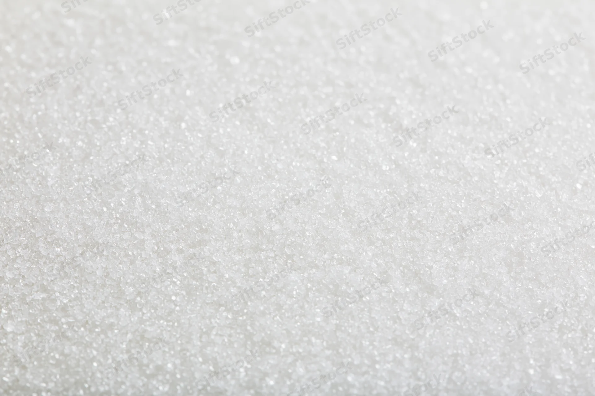 Close-up of granulated white sugar crystals filling the frame