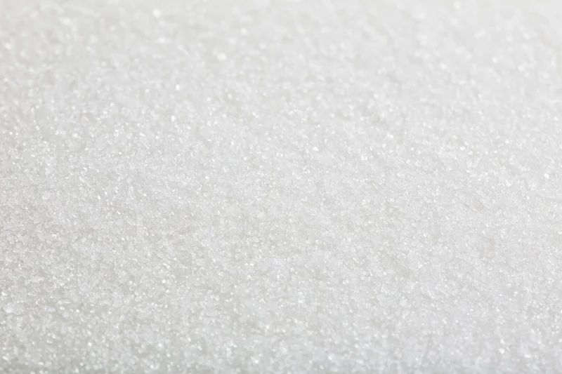 Close-up of granulated white sugar crystals filling the frame