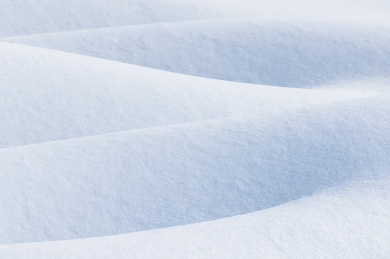 Smooth undulating snow drifts in a winter landscape
