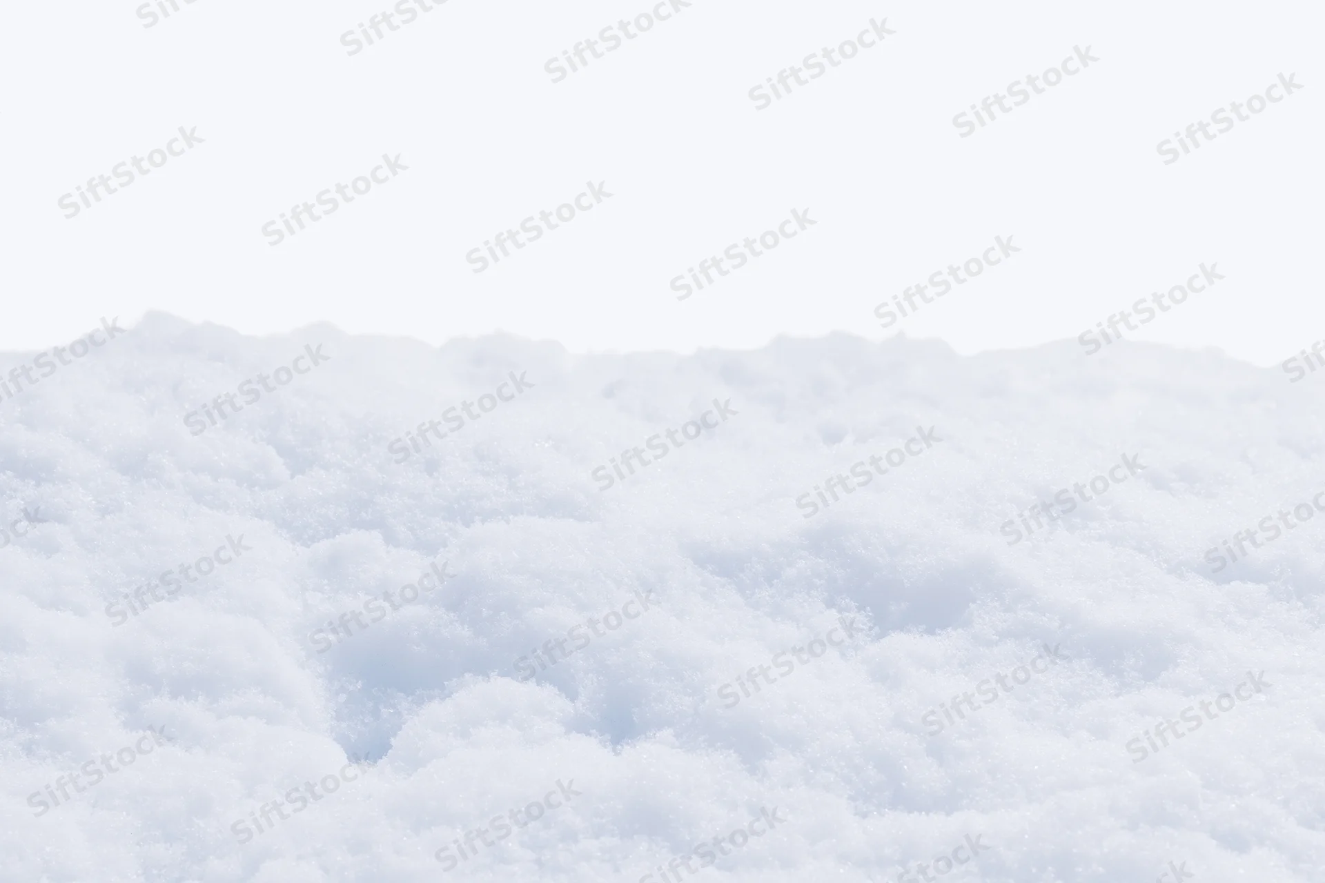 Closeup of fresh white snow covering a low mound outdoors in winter