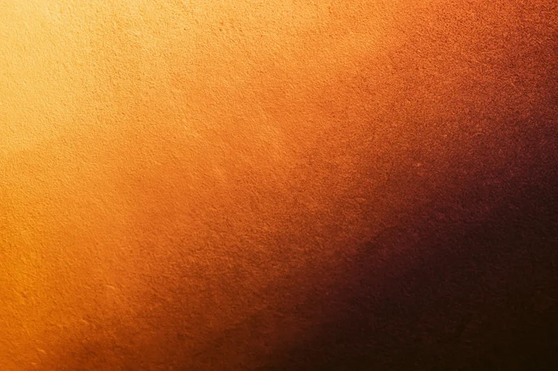 Warm orange gradient on a textured matte surface