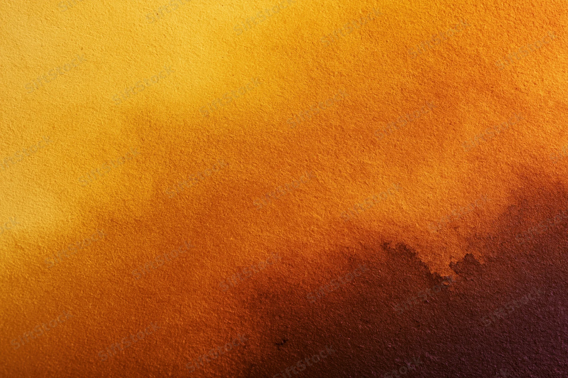 Warm gradient of orange and yellow paint on textured matte surface