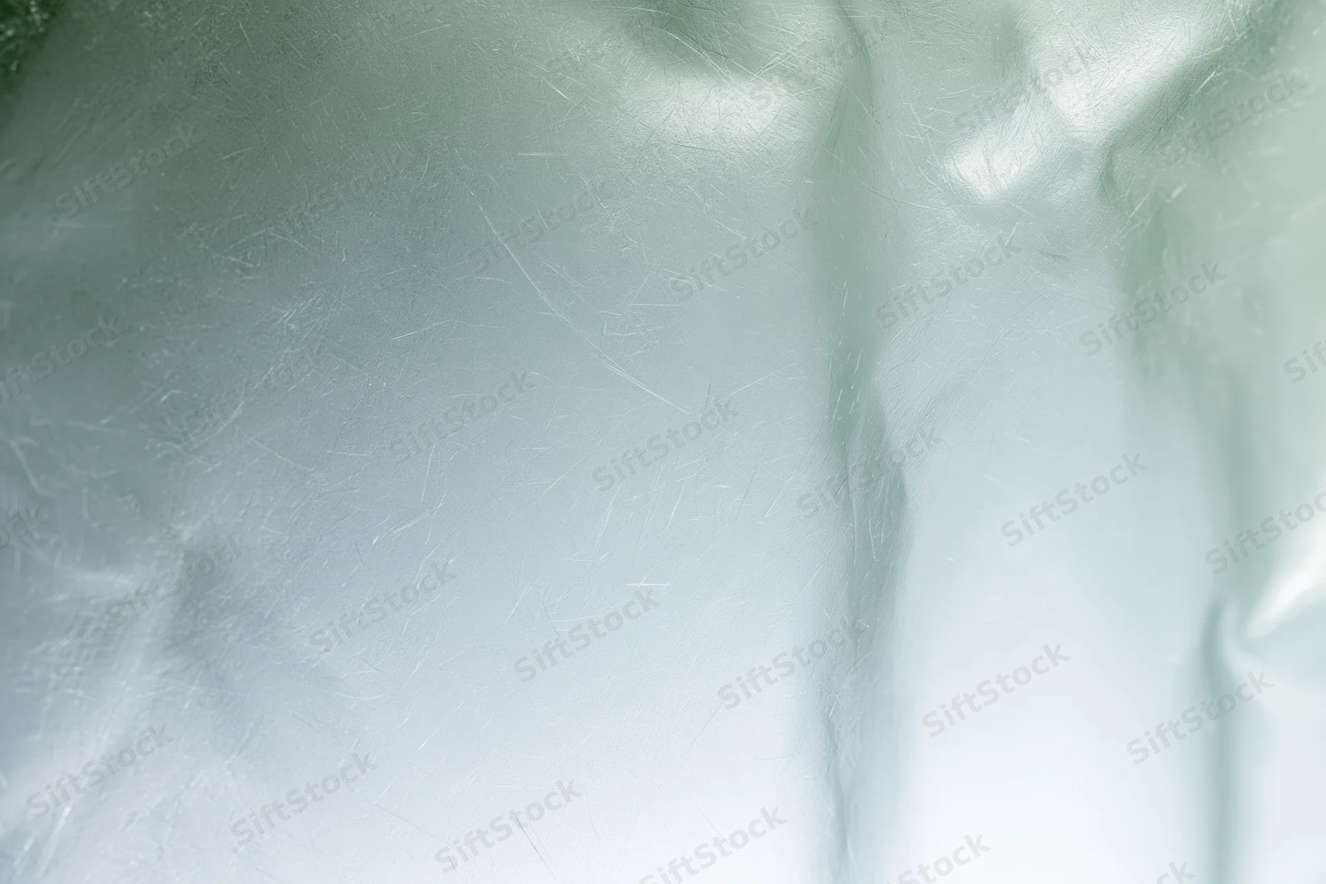 Close macro view of frosted translucent glass surface with soft light reflections and smooth texture