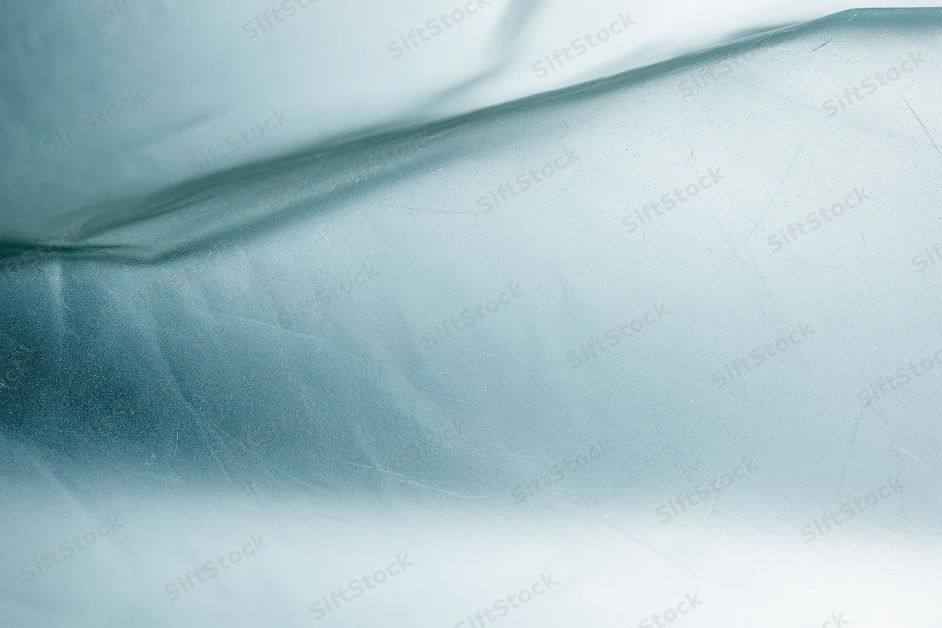 Close macro view of frosted translucent glass surface with soft light and shadow patterns