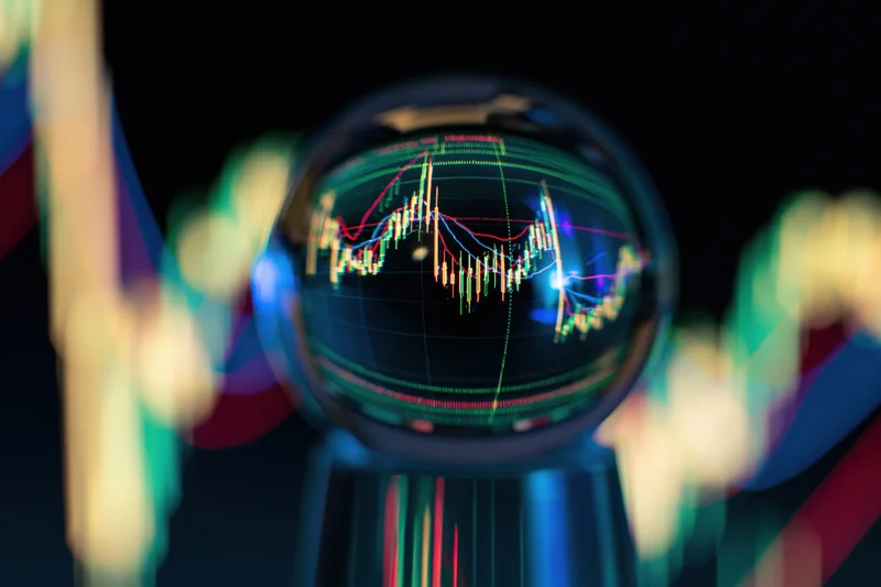 Crystal ball reflecting inverted stock market chart with candlestick data and colorful light trails around it