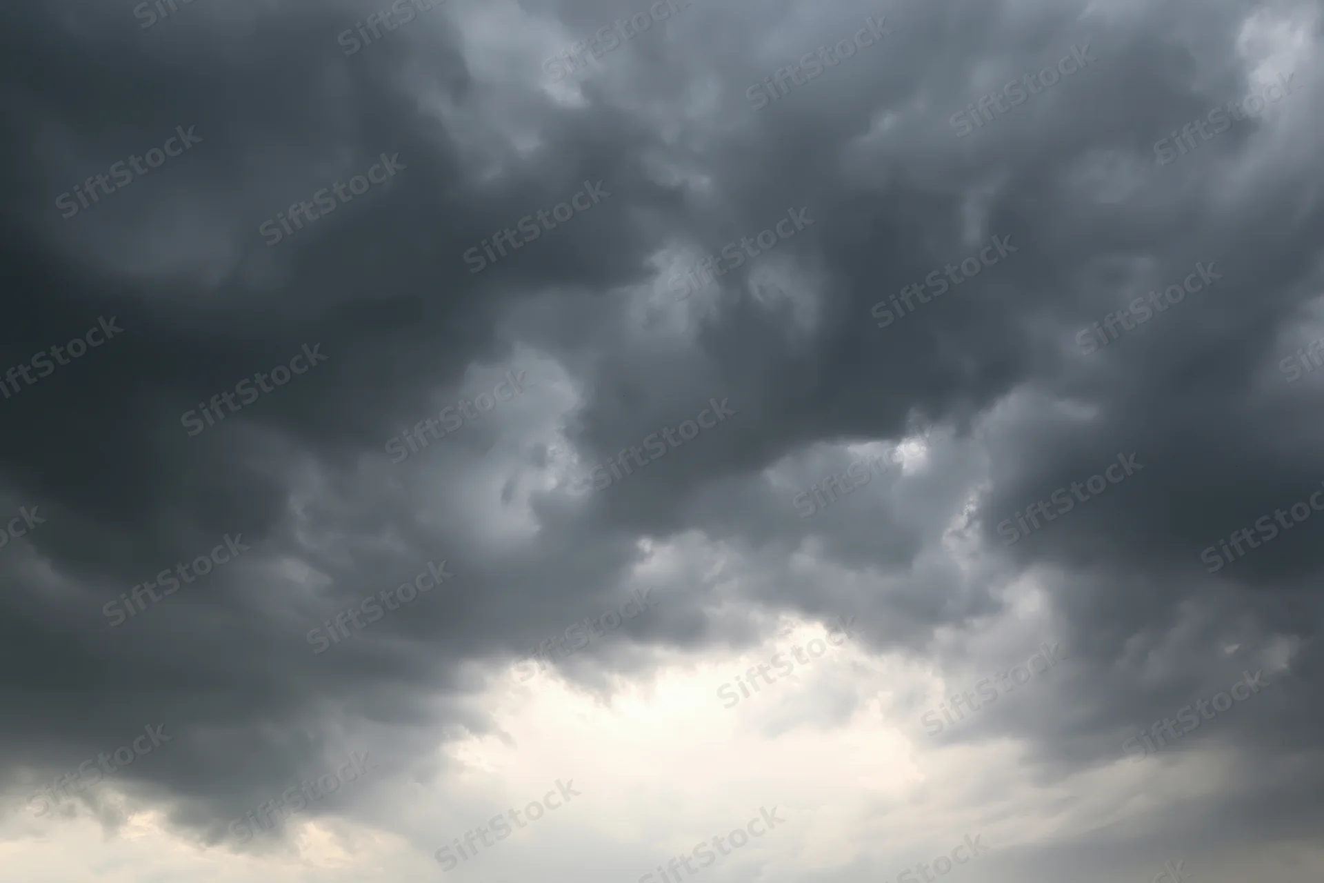 Dark storm clouds filling the sky with heavy cumulonimbus formations