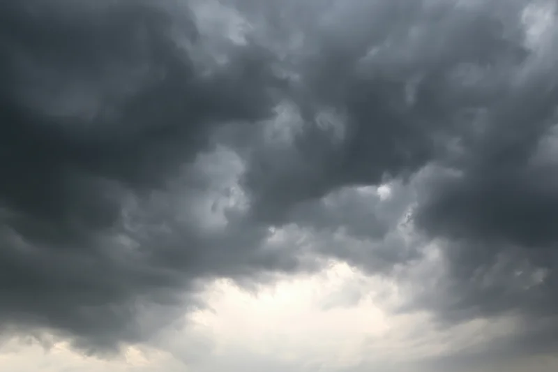 Dark storm clouds filling the sky with heavy cumulonimbus formations